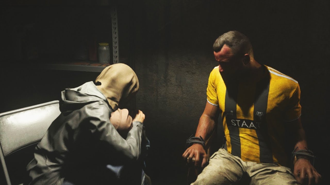 Immersed in shadow, a man sits next to two people, his face bruised. He wears a bright yellow shirt and brownish-white pants. He is tied down to the chair he's sitting in. One of the people next to him, his wife, has a sack over her head, and is bent over the form of the third person, their child, who also has a sack on their head.